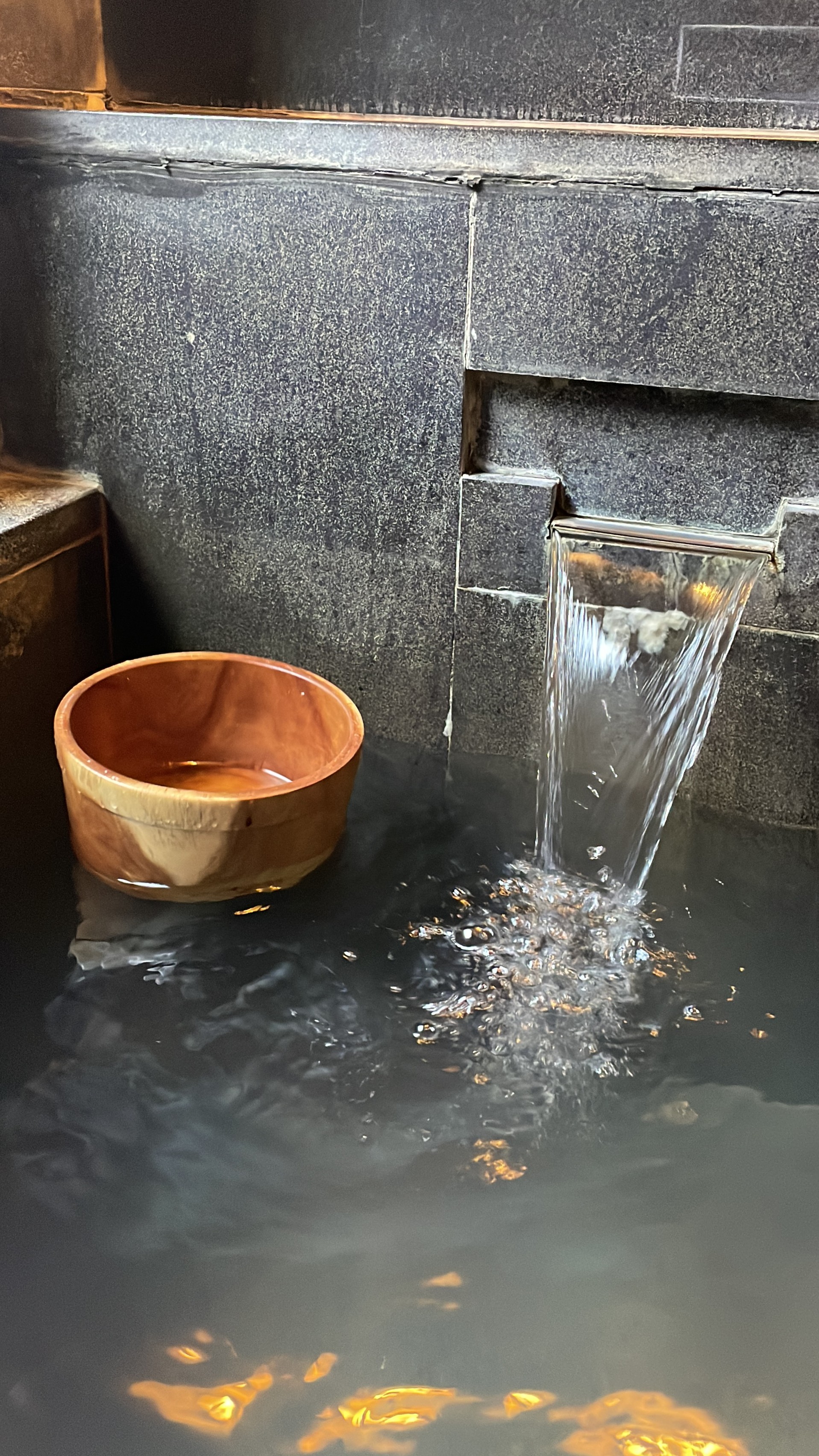 Wooden bucket flowing water