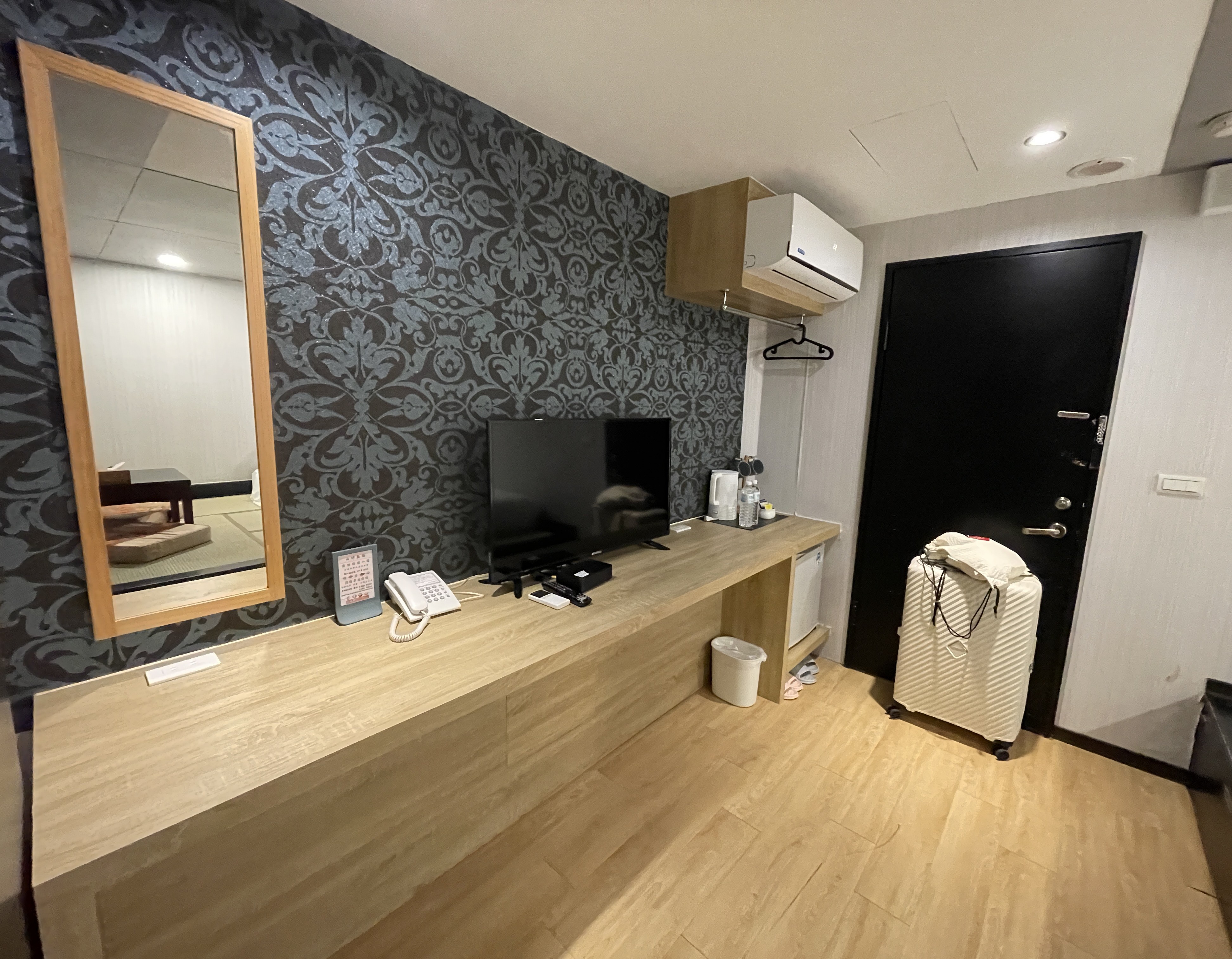 TV wall with black pattern wallpaper