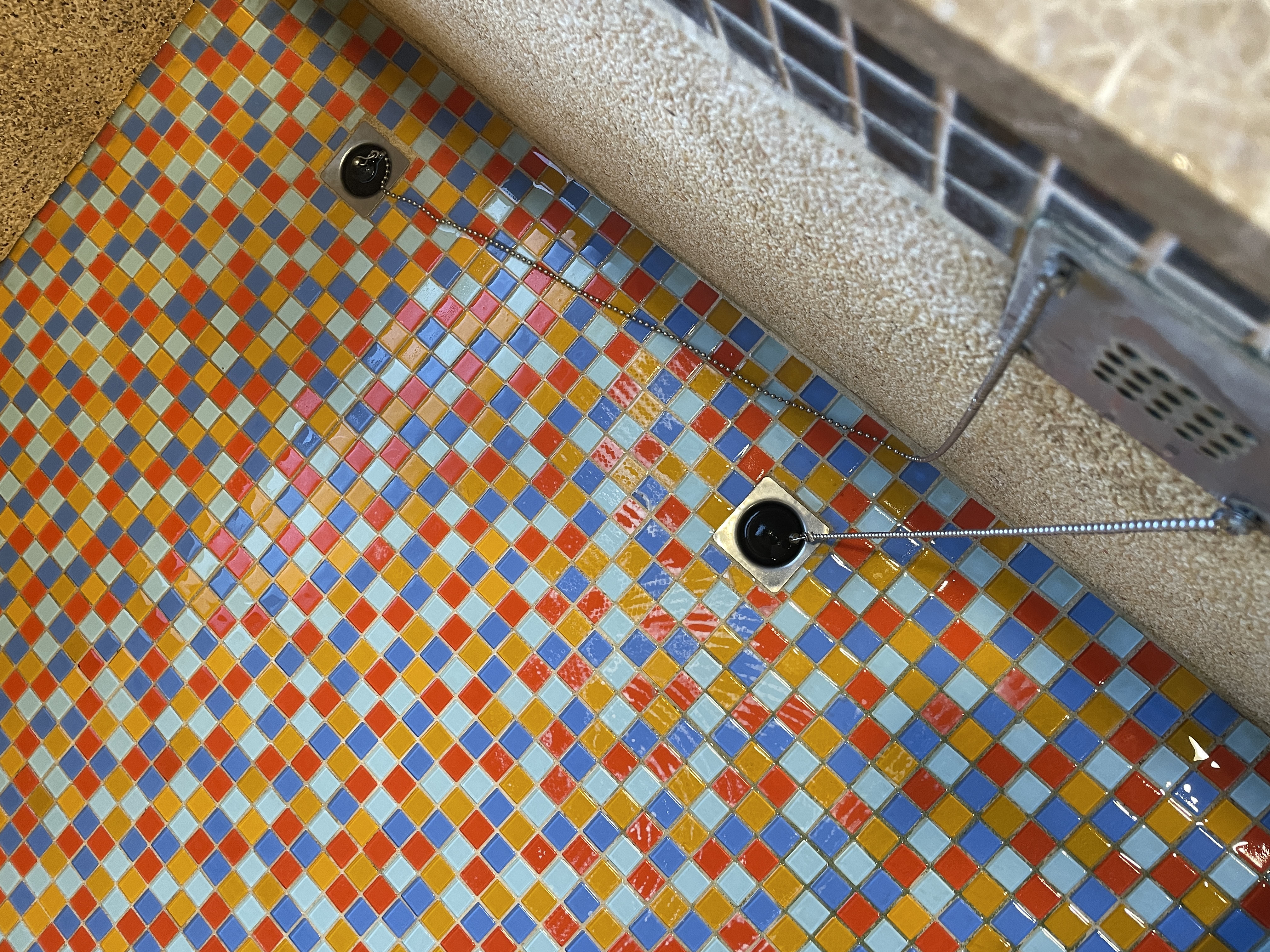 Ball chain drain plug on mosaic floor